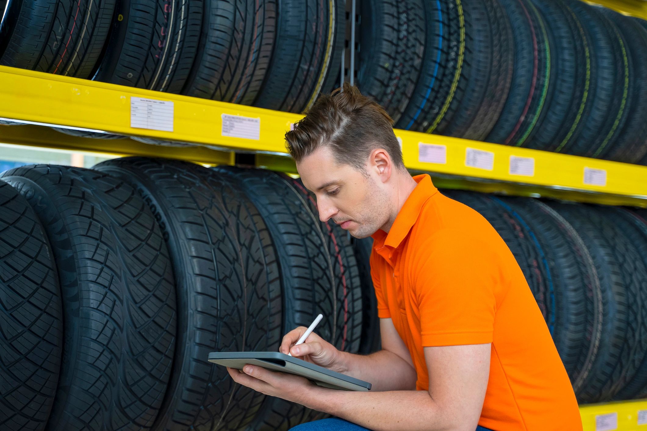 Employee checking a tire at a service station